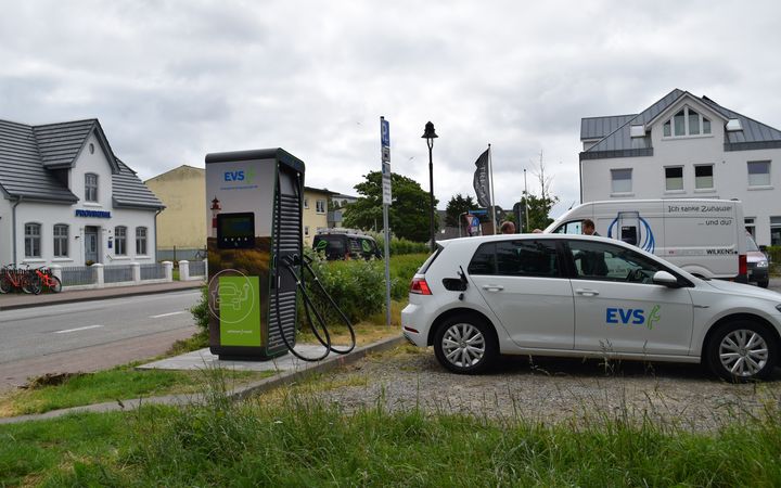 Der neue Hypocharger der EVS mit einem ladebereiten Auto davor